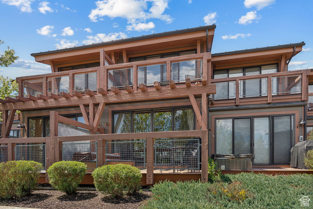Rear view of house featuring a balcony