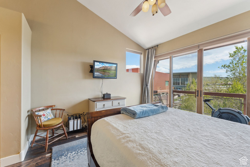 Bedroom featuring dark wood-style floors, lofted ceiling, access to outside, baseboards, and ceiling fan