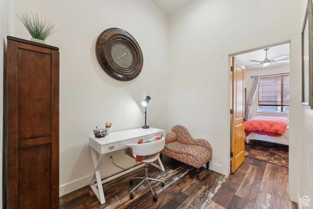 Office area with dark wood-style flooring, baseboards, and a ceiling fan