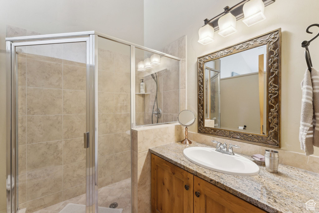 Full bath with vanity and a stall shower