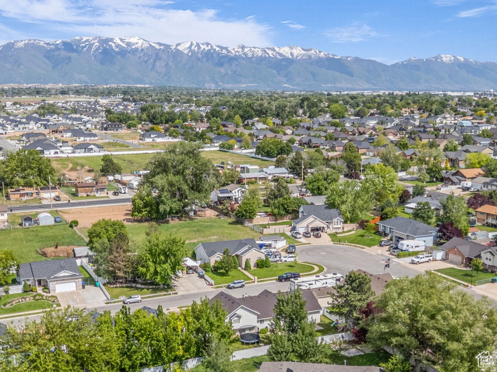 Aerial view of property's location with nearby suburban area and mountains