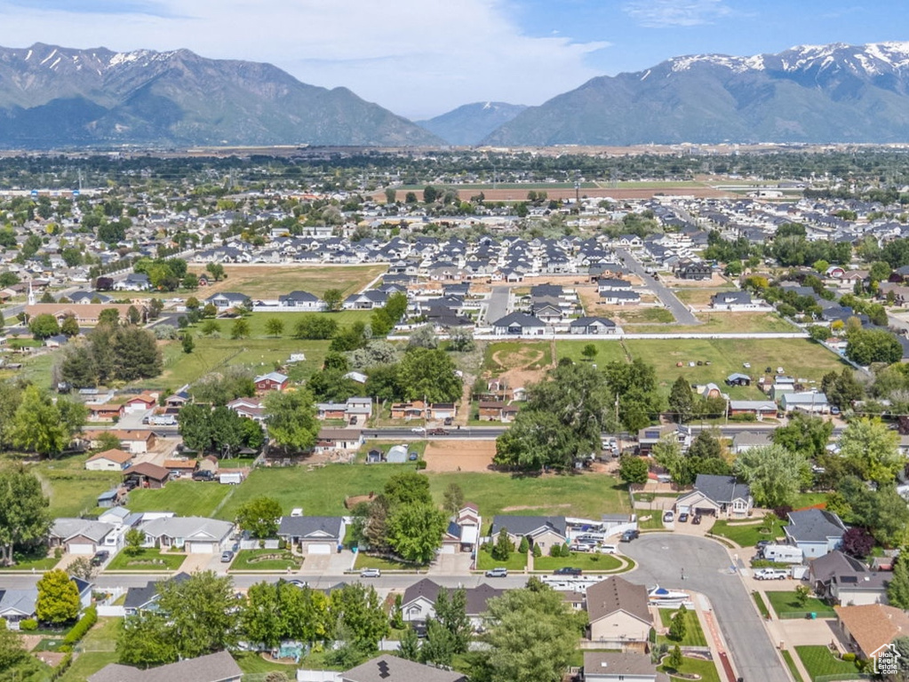 Aerial view of property's location featuring a mountainous background and nearby suburban area