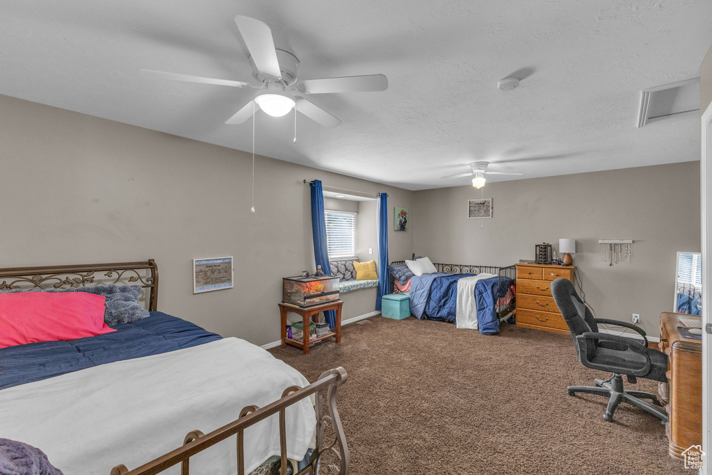 Carpeted bedroom with baseboards and ceiling fan