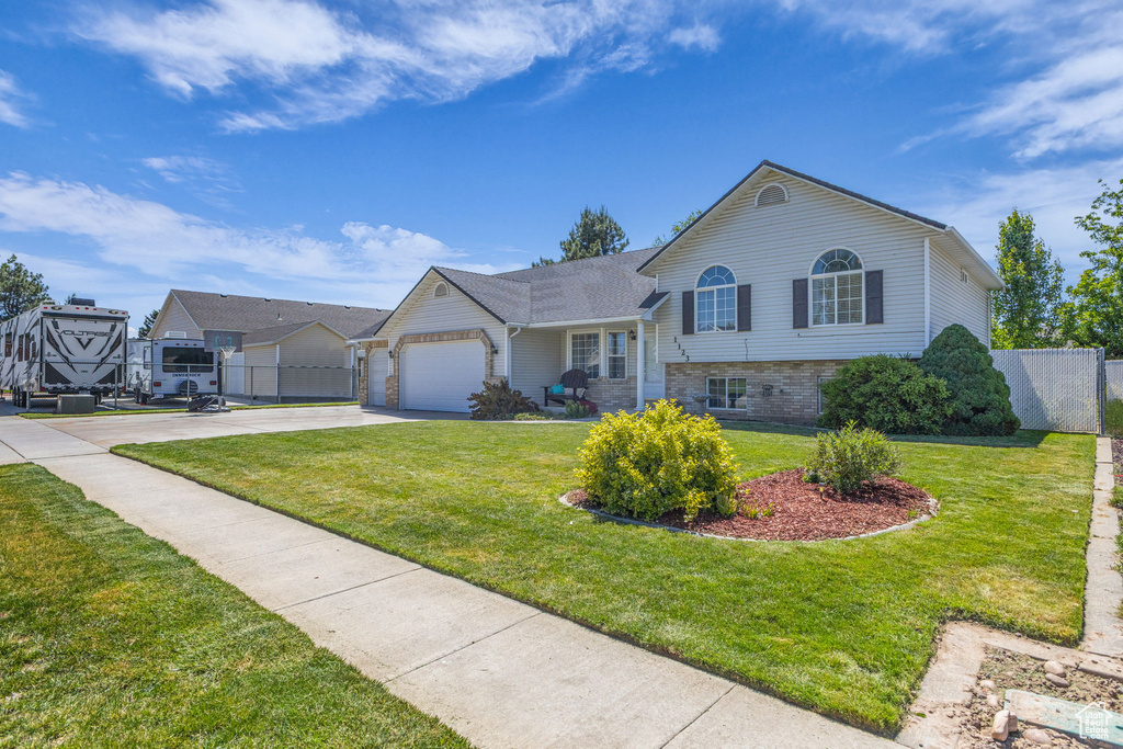 Tri-level home featuring driveway and an attached garage