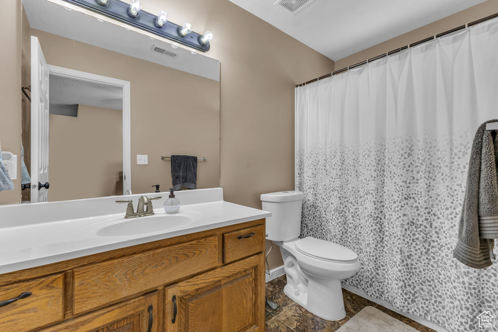 Full bathroom featuring vanity, toilet, tile patterned flooring, and a shower with curtain