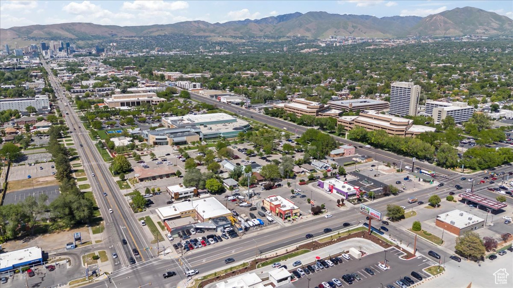 View of urban area with a mountain backdrop and a highway