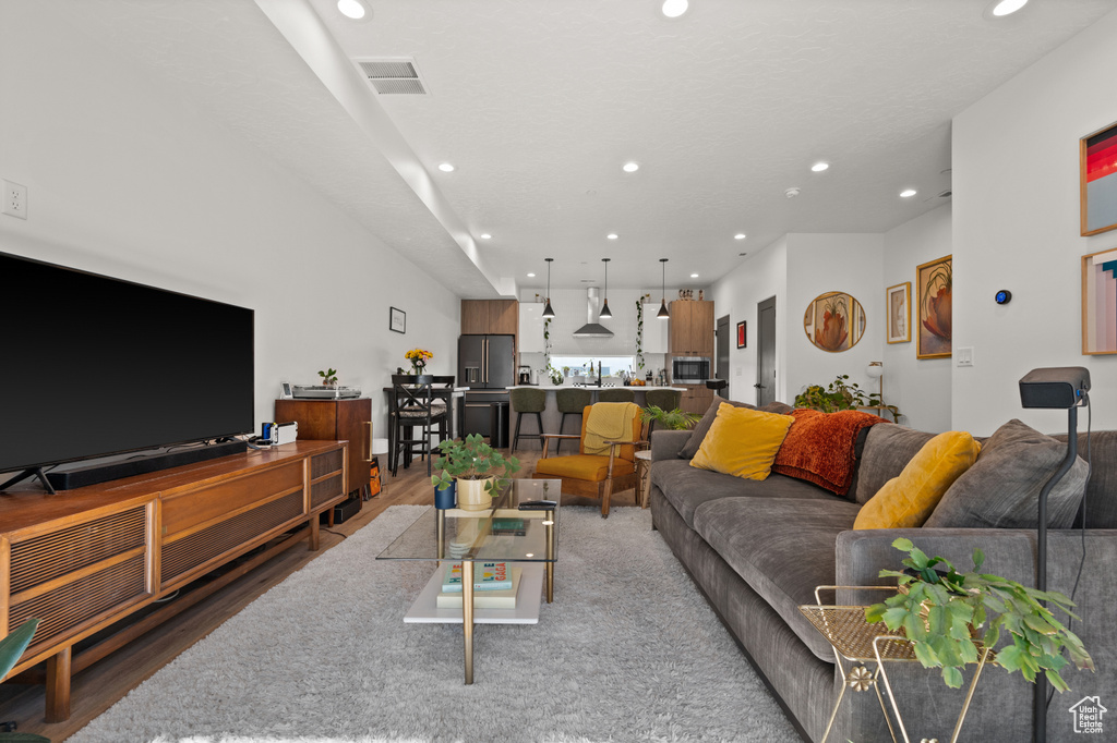 Living room featuring recessed lighting and light wood-type flooring