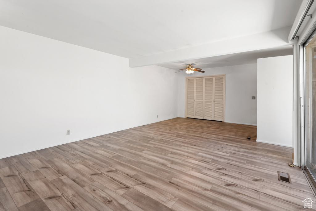 Unfurnished room with light wood-style floors and ceiling fan