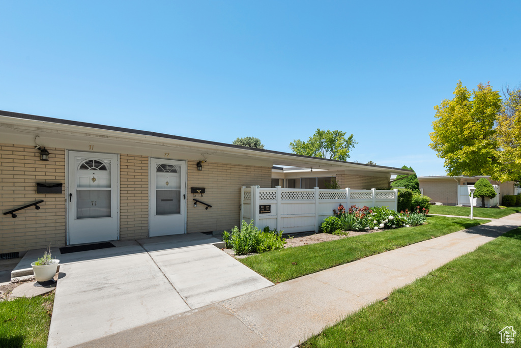 View of front facade with brick siding and a front yard