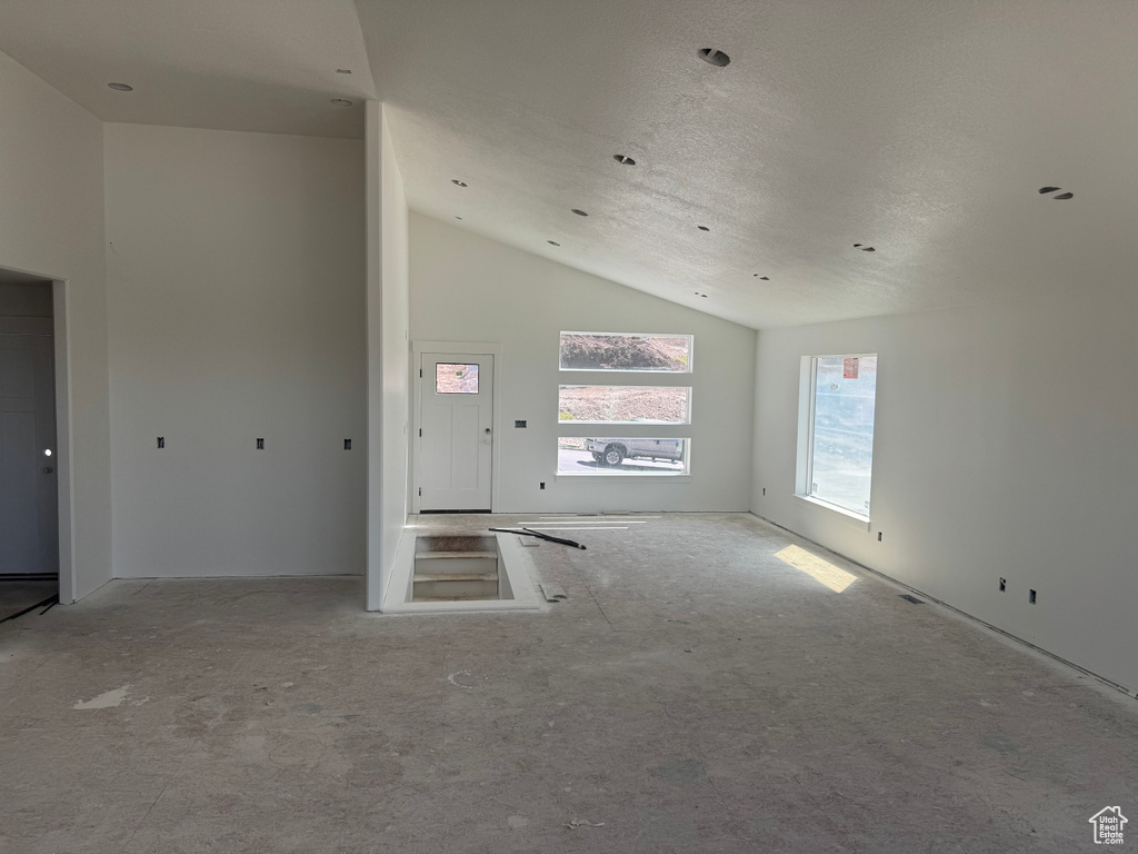 Spare room featuring lofted ceiling and a textured ceiling