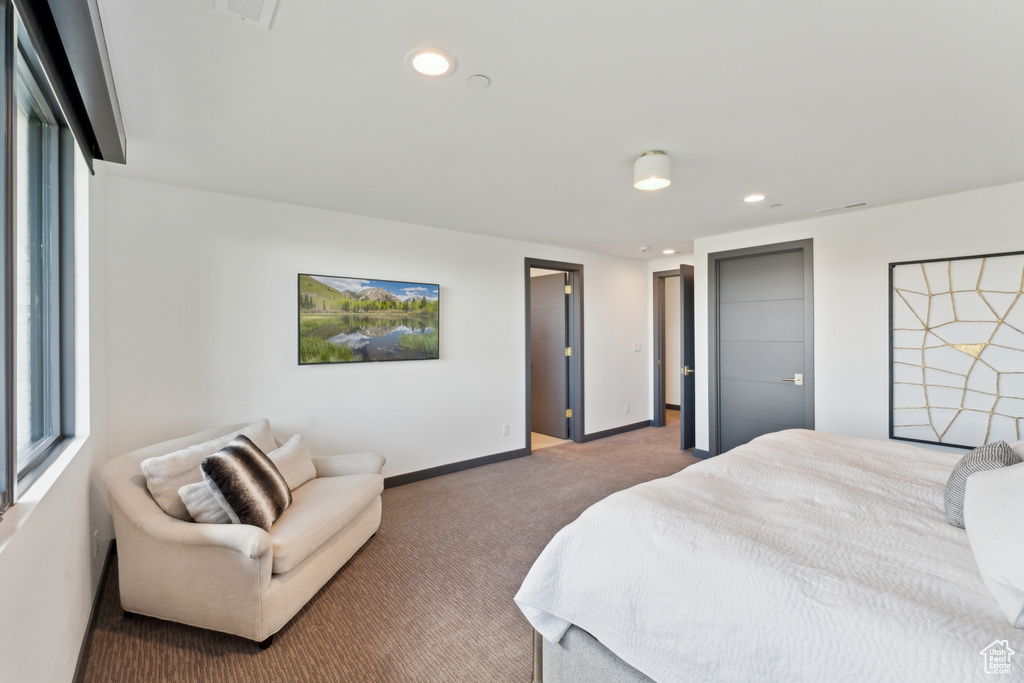 Carpeted bedroom featuring recessed lighting, baseboards, and multiple windows