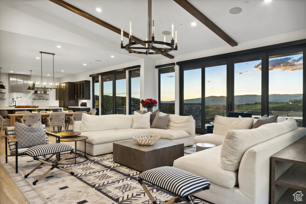 Living area featuring a chandelier, light wood-style floors, and recessed lighting