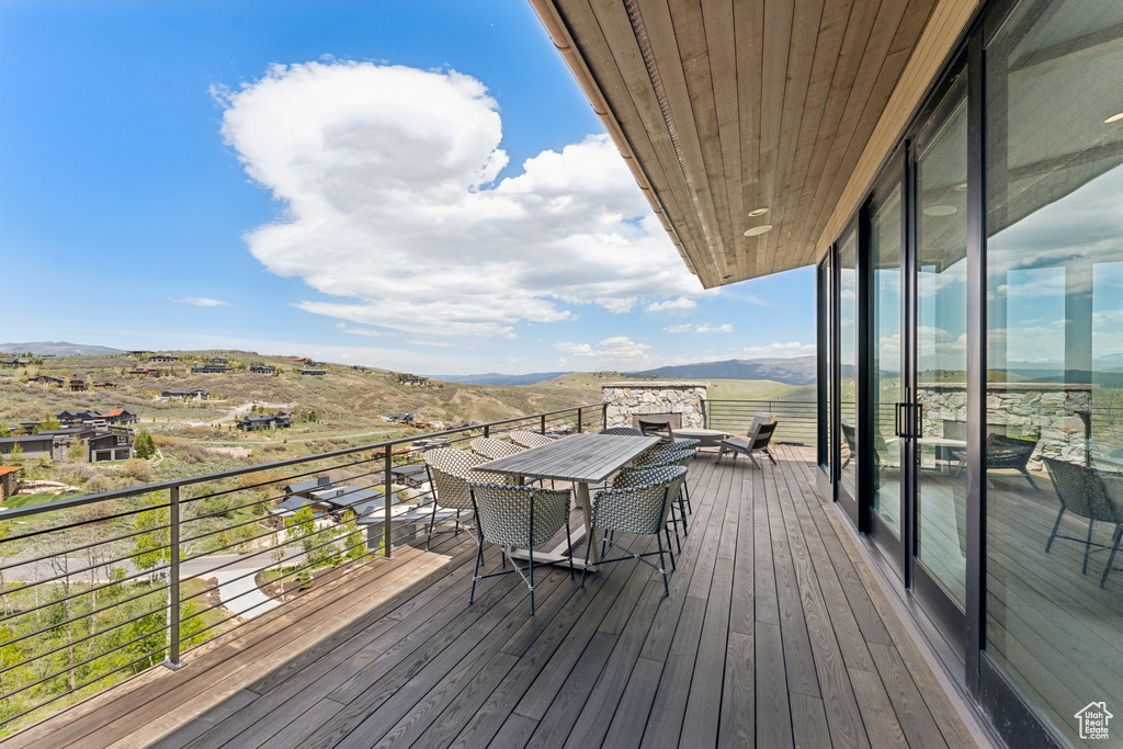 Deck featuring a mountain view and outdoor dining space