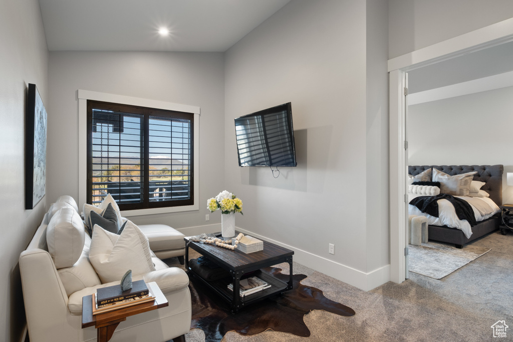 Carpeted living room with baseboards and recessed lighting