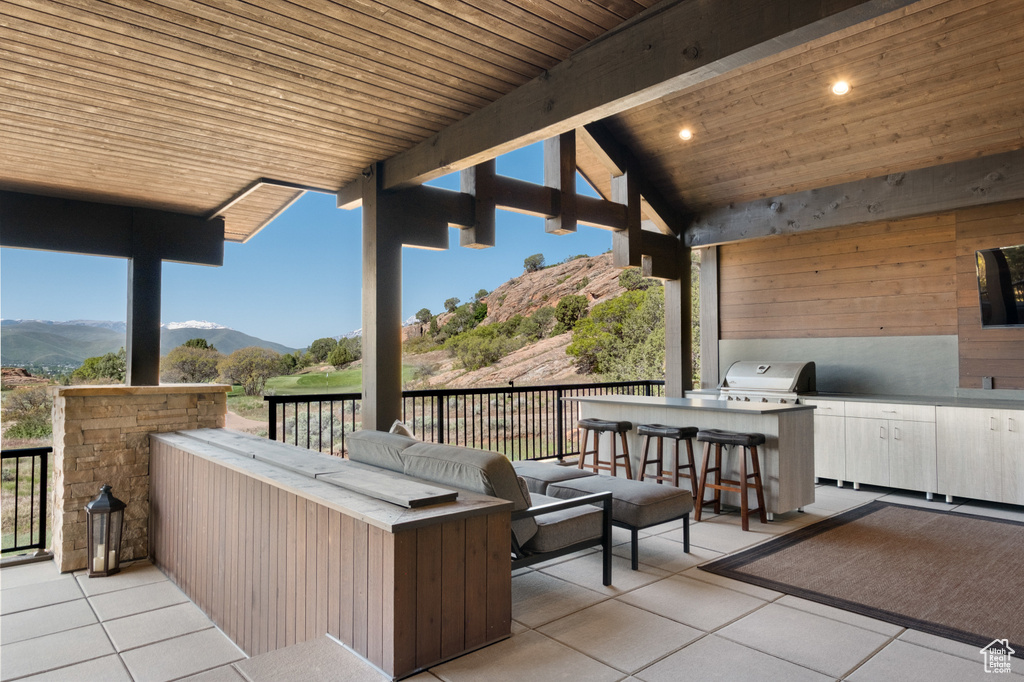 View of patio with a mountain view and an outdoor kitchen