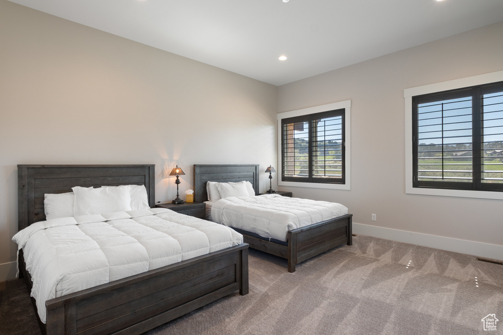 Bedroom with light carpet, recessed lighting, and baseboards