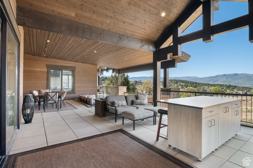 View of patio with a mountain view and an outdoor living space