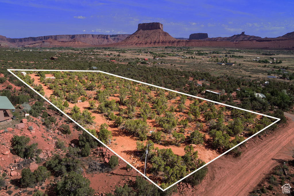 Overview of rural landscape with property boundaries highlighted and a mountain backdrop