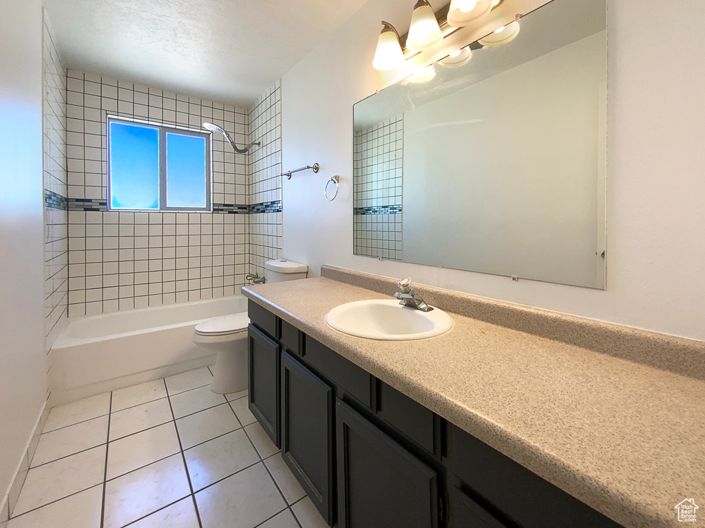 Full bath featuring vanity,  shower combination, toilet, and tile patterned floors