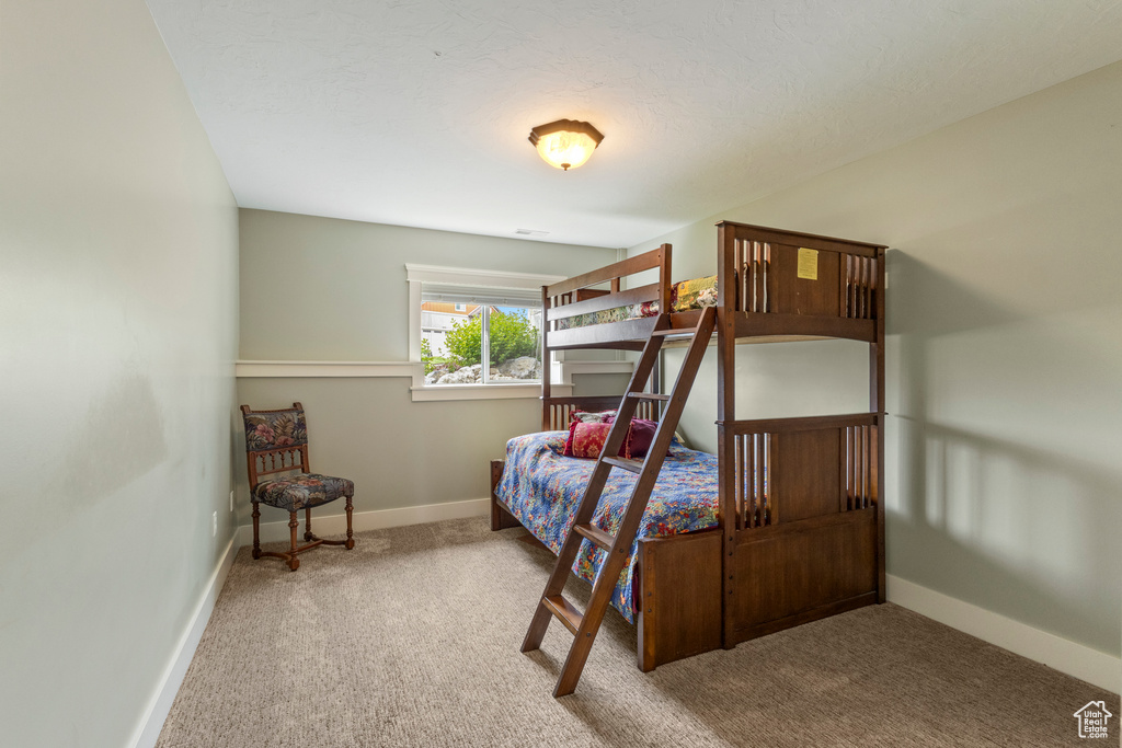 Bedroom featuring carpet floors and baseboards