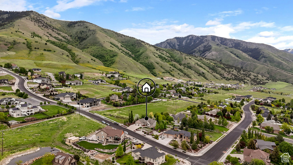 View of mountain backdrop featuring nearby suburban area