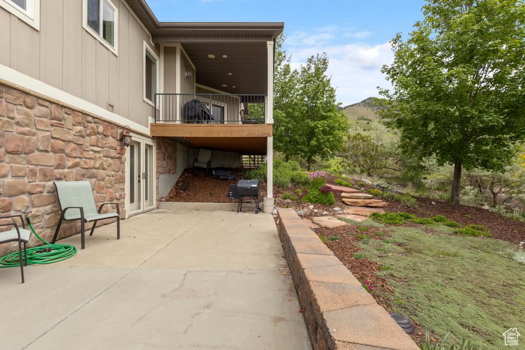 View of patio / terrace featuring a balcony and a grill