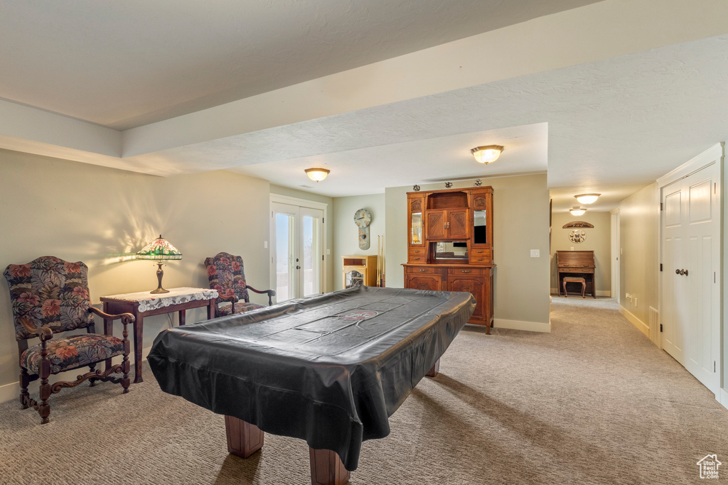 Rec room with light carpet, pool table, french doors, and baseboards
