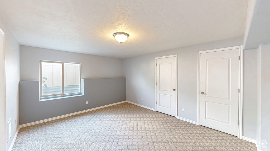 Unfurnished bedroom featuring carpet floors and baseboards
