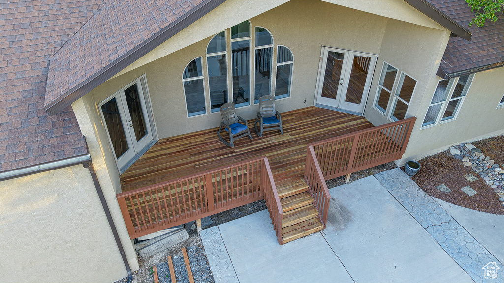 Wooden deck featuring french doors and a patio area