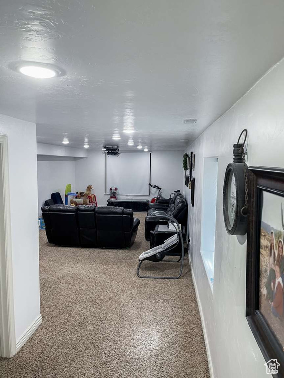 Carpeted living area featuring baseboards