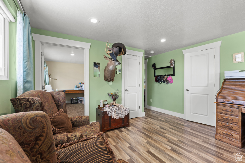 Living area featuring wood finished floors, recessed lighting, and baseboards