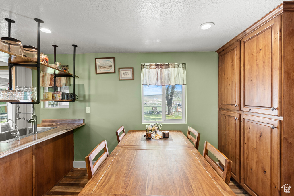 Dining area with recessed lighting, wood finished floors, and a textured ceiling