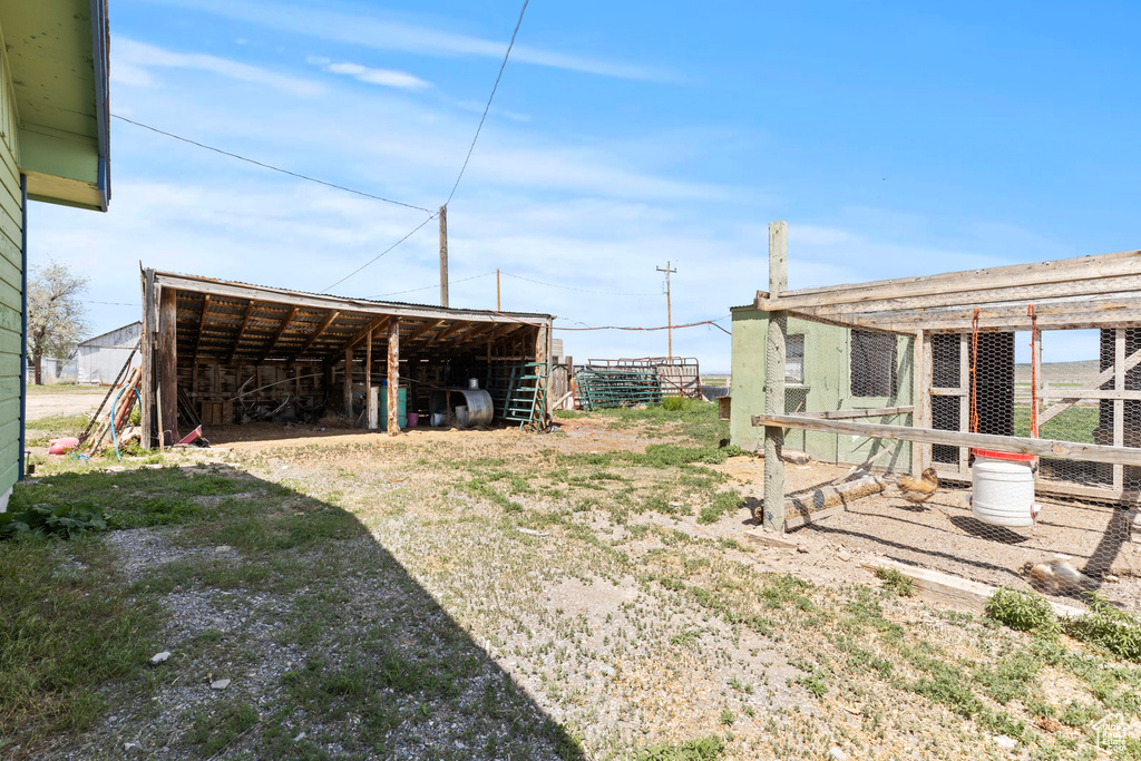 View of yard featuring an outbuilding, a pole building, and exterior structure
