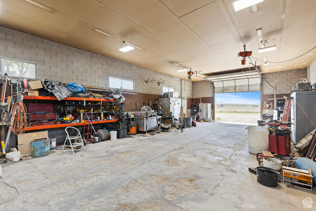 Garage with a workshop area and concrete block wall