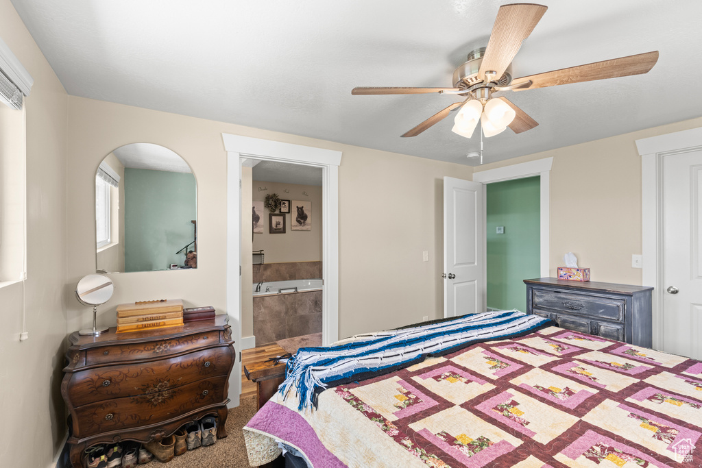 Bedroom with a ceiling fan and ensuite bathroom