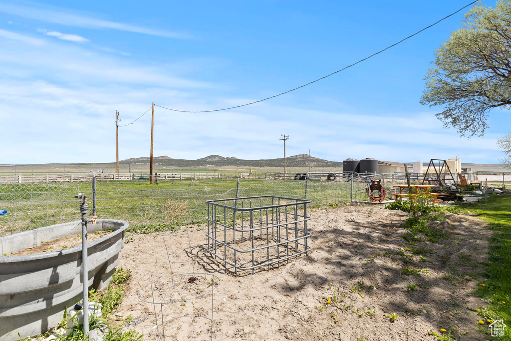 View of yard featuring a rural view and a mountain view