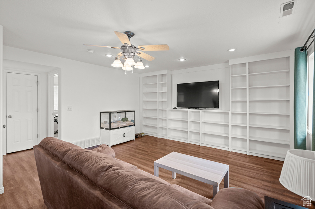 Living room featuring a ceiling fan, wood finished floors, recessed lighting, and baseboards