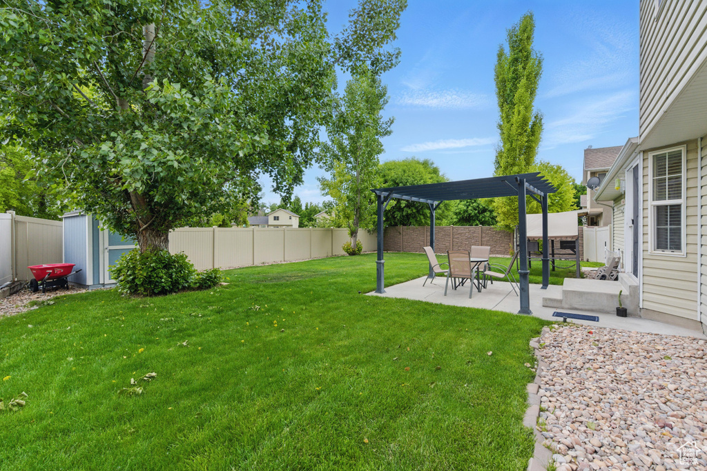 View of yard with a pergola and a patio
