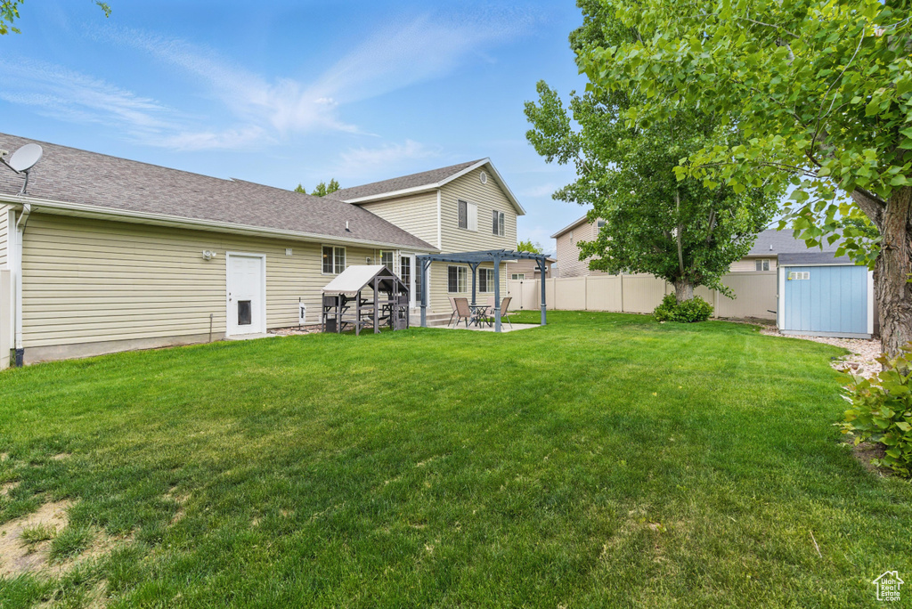 Rear view of house featuring a patio area and a pergola