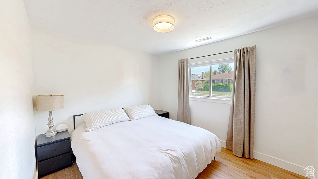 Bedroom featuring light wood finished floors and baseboards