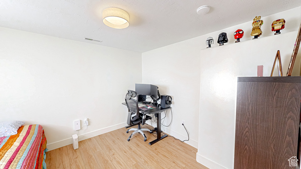 Office with wood finished floors and baseboards