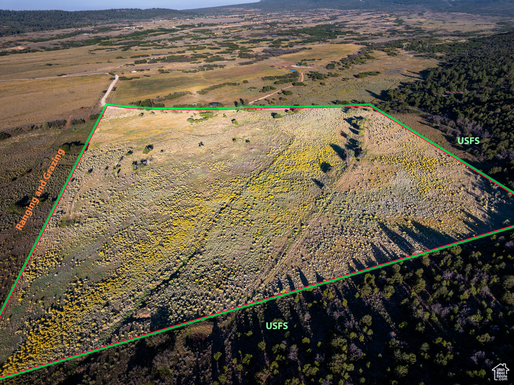 Aerial view of sparsely populated area featuring property parcel outlined