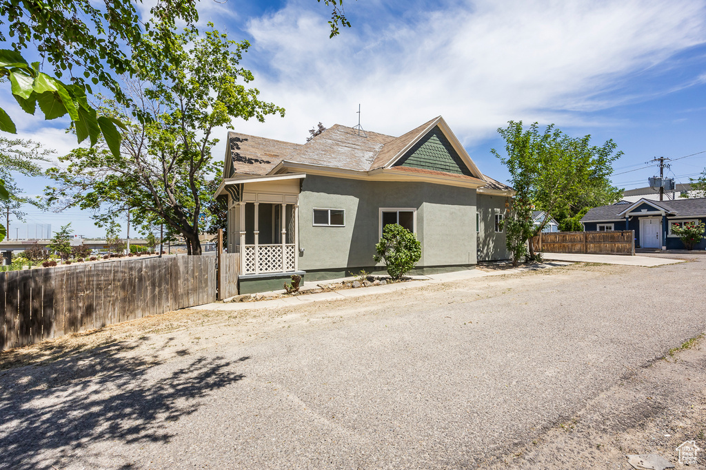 View of front facade with stucco siding and a sunroom