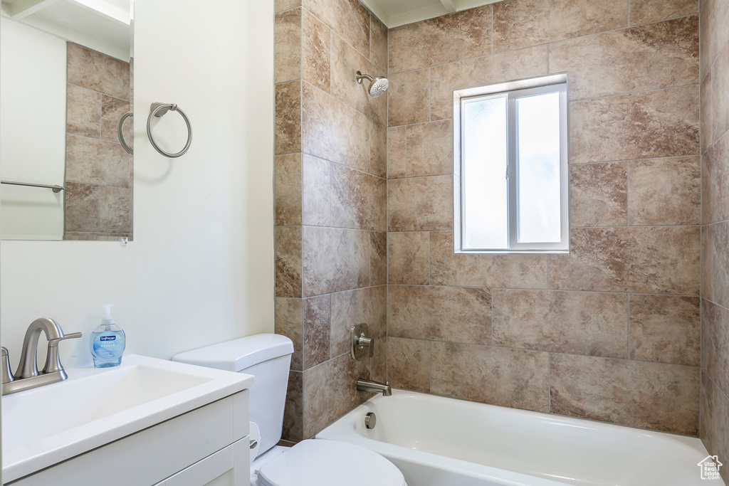 Bathroom with toilet, vanity, and bathing tub / shower combination