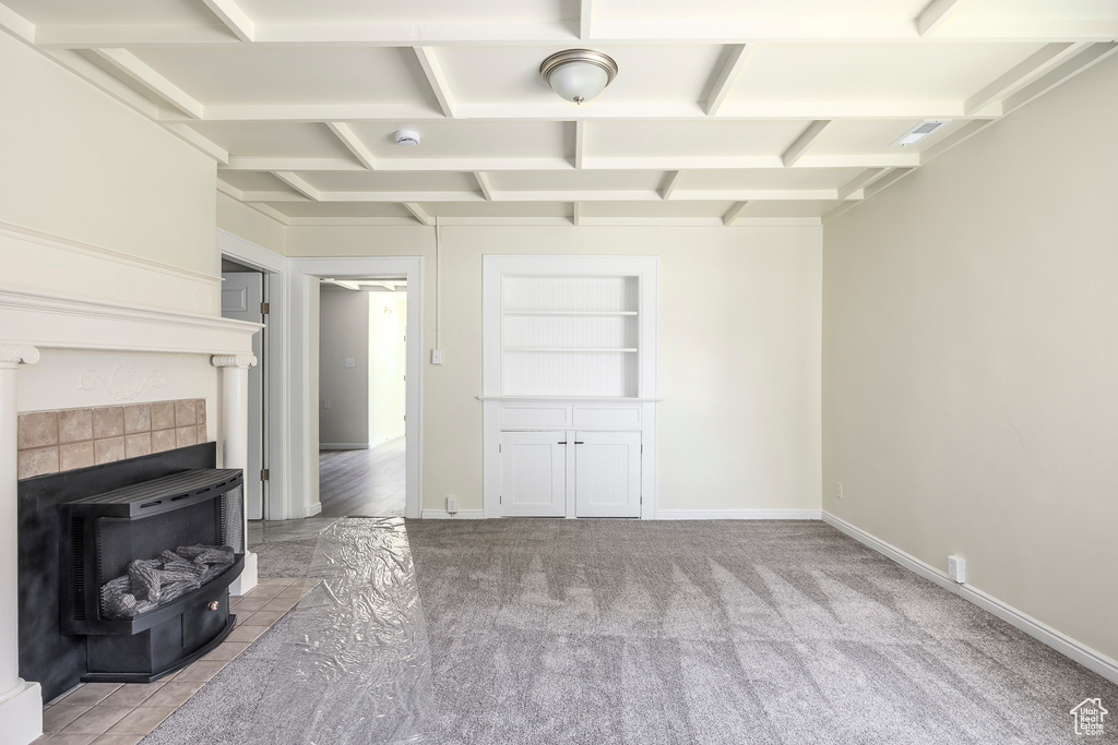 Unfurnished living room with carpet, baseboards, and built in features