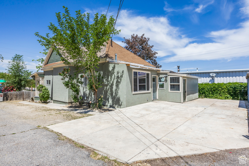 Rear view of house featuring a patio area and stucco siding