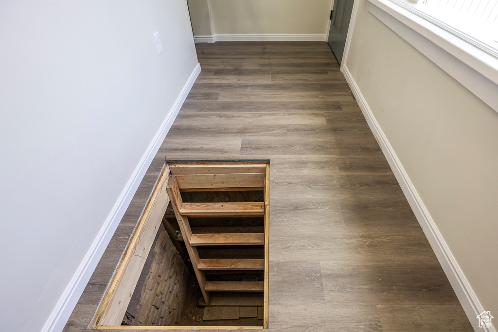 Stairs with baseboards and wood finished floors