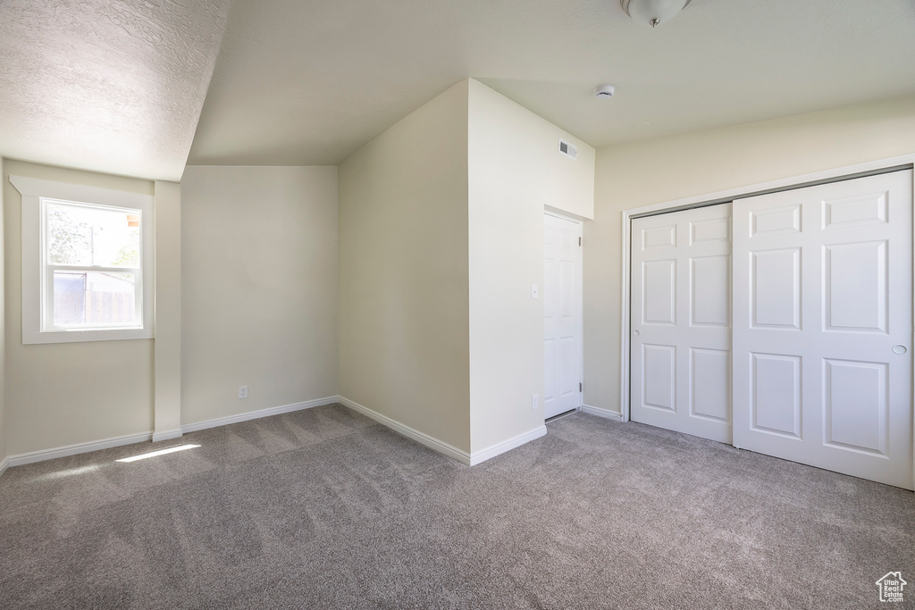 Bonus room with carpet floors and baseboards