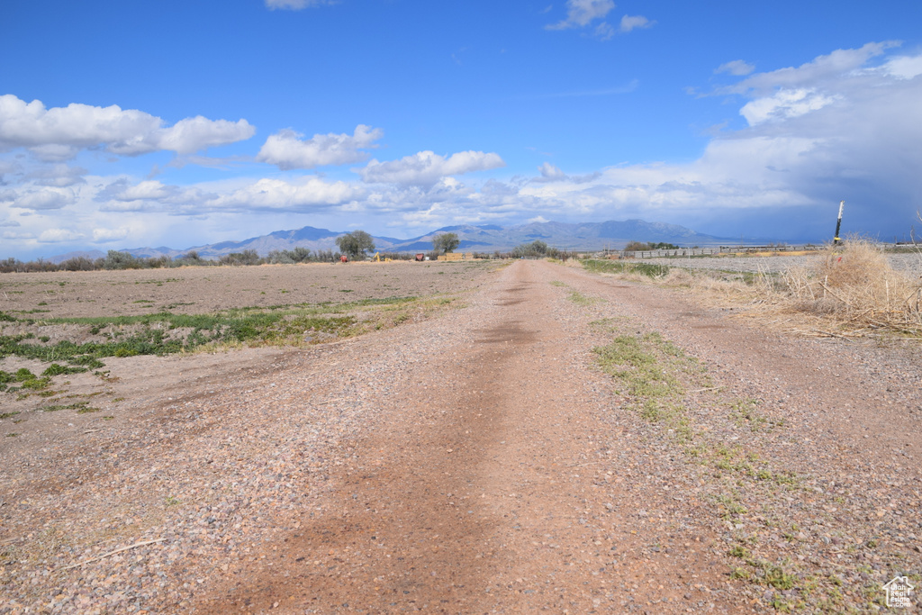 View of dirt / gravel road featuring a mountain view and a rural view