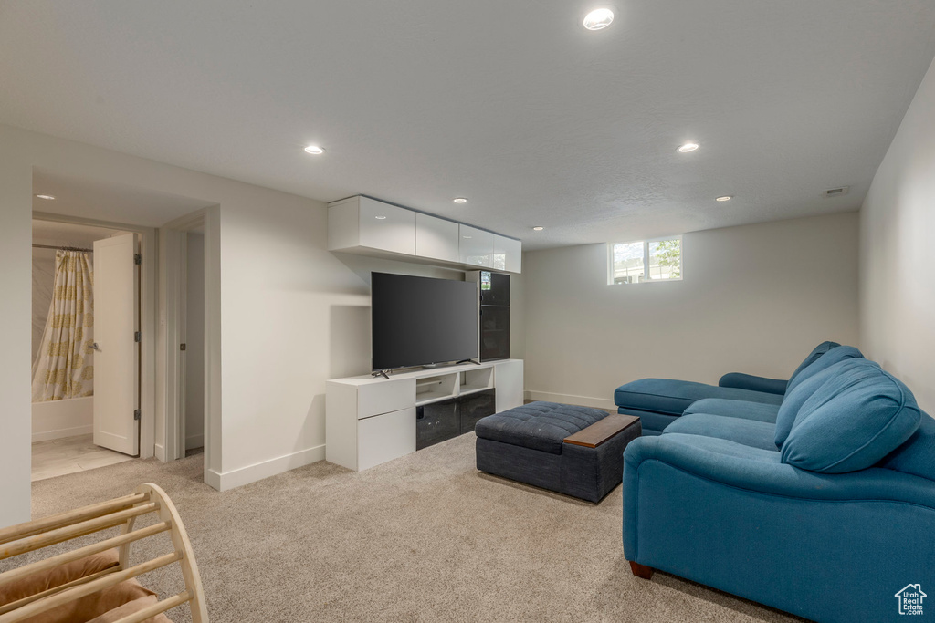 Living area featuring recessed lighting, baseboards, and light colored carpet
